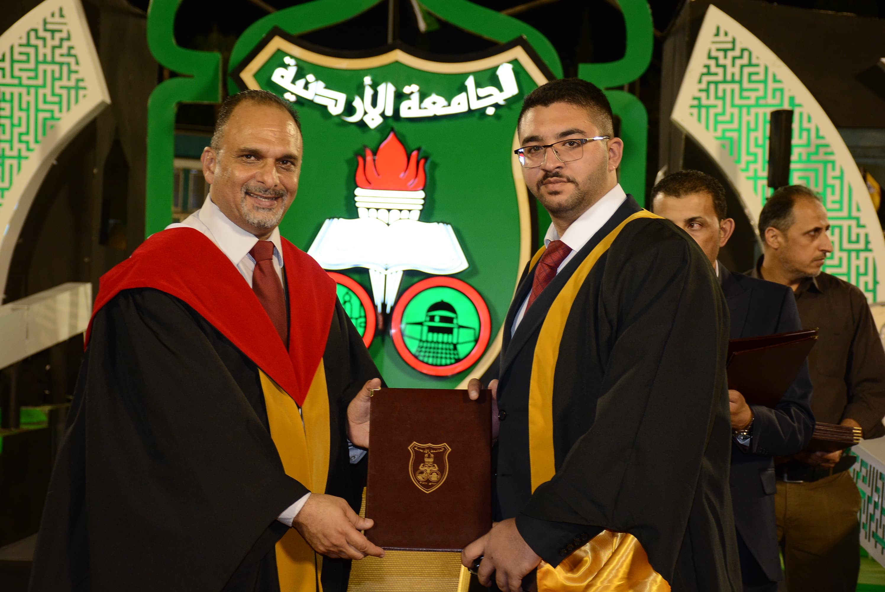 Wissam Almahasneh receiving his degree at the University of Jordan graduation ceremony
